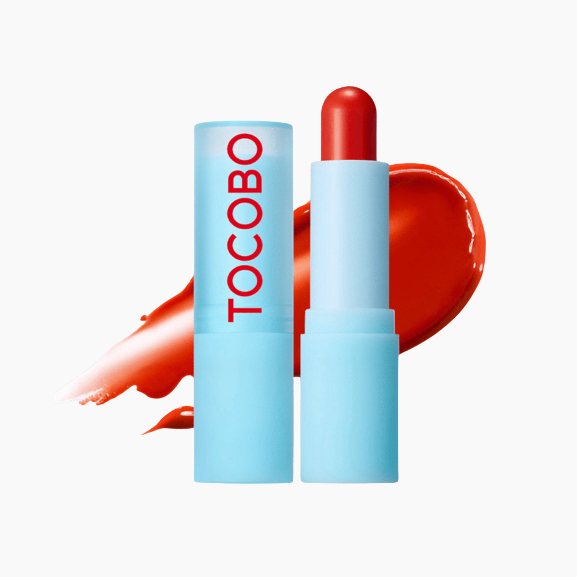 Hellblauer Tocobo Lip Balm in Orange geöffnet vor passendem Farbswatch – nährende Lippenpflege mit Glanzeffekt