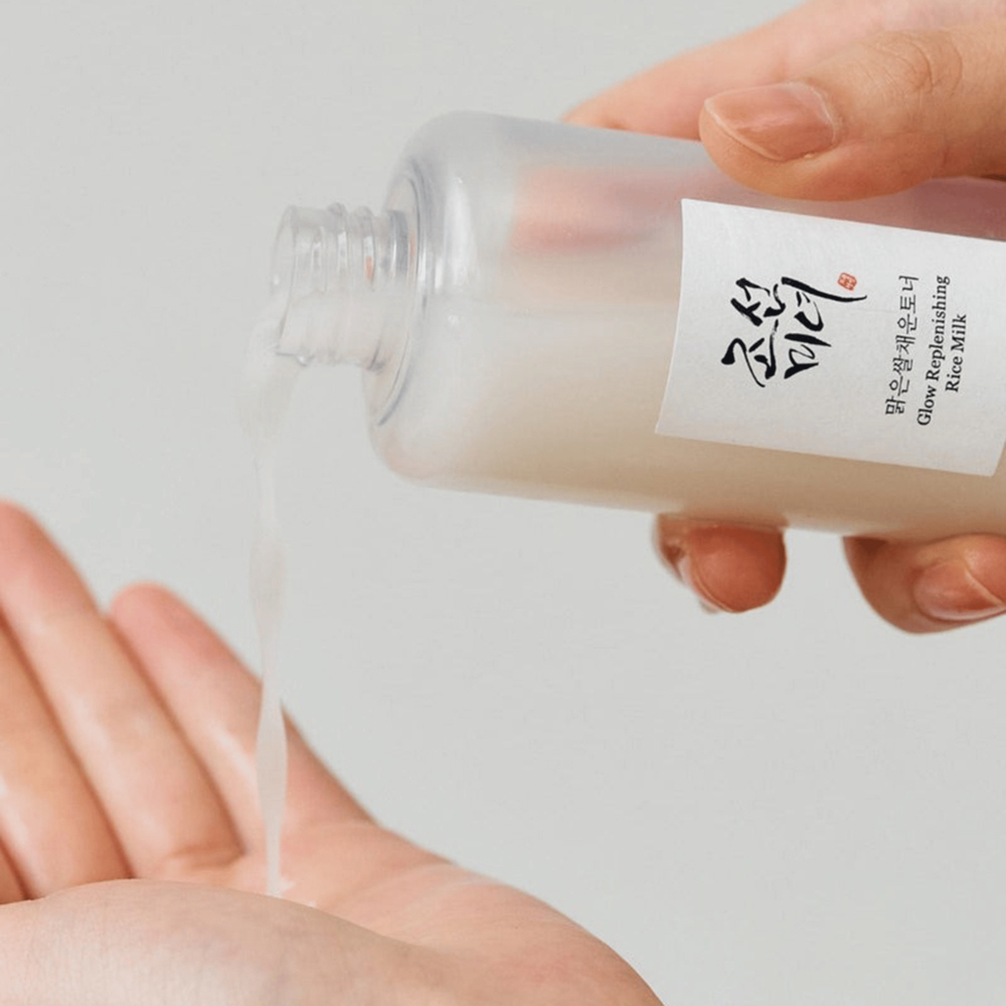 Beauty of Joseon Glow Replenishing Rice Milk wird in die Handfläche gegossen – milchige Textur für ein strahlendes Hautbild