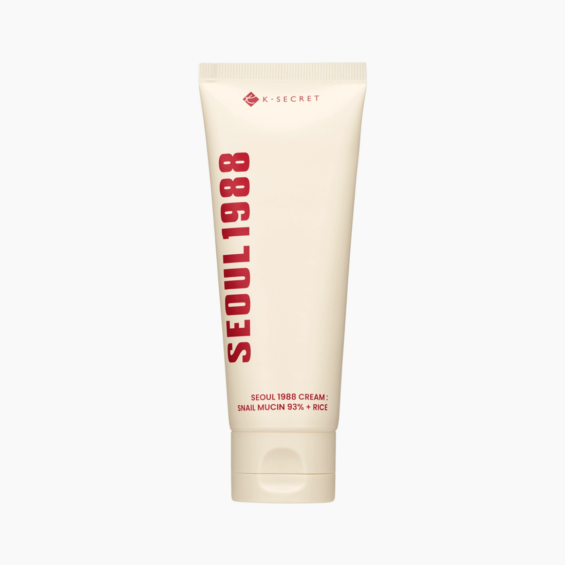 Eine beigefarbene Tube von K-Secret SEOUL 1988 Cream Snail Mucin 93% + Rice 100ml steht aufrecht vor einem weißen Hintergrund.
