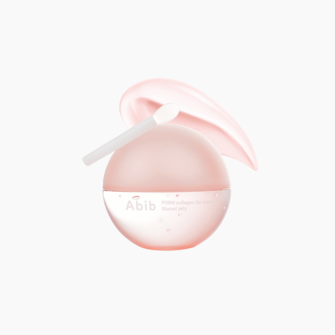 Eine rosafarbene, kugelförmige Abib PDRN Collagen Lip Mask mit einem kleinen Applikator auf der Oberseite ist vor einem weißen Hintergrund abgebildet.